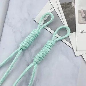 Detail view of light green 5mm braided paracord lanyard with a secure coiled wrap