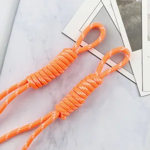 Detail of 5mm orange braided paracord lanyard with white dots for DIY crafts