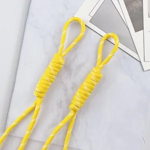 Detail view of 5mm yellow braided polyester lanyard for DIY keychain and phone bag charms.