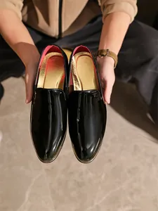 Glossy black patent leather loafers for men, formal slip-on business shoes.