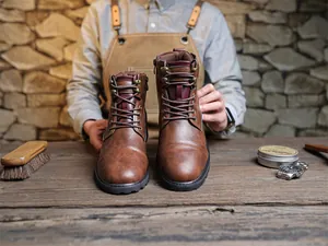 Front view of high-quality brown retro leather Martin boots displayed on a rustic wood table