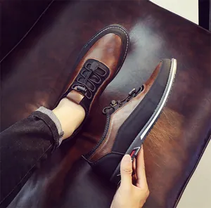 Close-up of premium brown and black leather casual loafers for men on a leather sofa