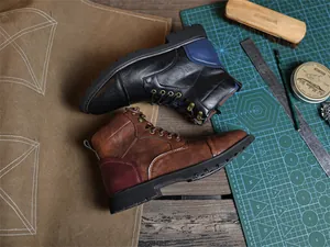 Detailed top view of retro vintage leather Martin boots in black and brown colors on a rustic table