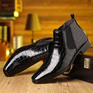 Gedetailleerd macrobeeld van zwarte heren Chelsea boots van leer met een luxe krokodillenprint
