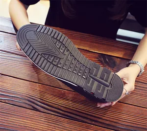 Detailed macro view of the anti-slip rubber sole on men's breathable casual loafers.