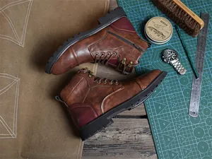 Top view of retro brown men's Martin boots in a creative workshop setting