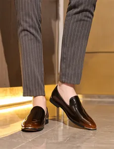 Close-up detail of premium men's glossy gradient leather loafers with metal toe