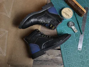 Detailed top view of men's vintage high-top work boots with navy blue heel accent.