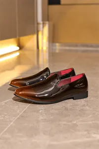 Close-up of high-gloss gradient brown men's formal loafers with red lining