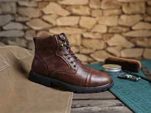 Vintage brown leather Martin boot for men in a workshop setting with craft tools.