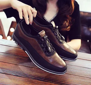 Close-up of brown and black leather men's slip-on loafers with elastic laces