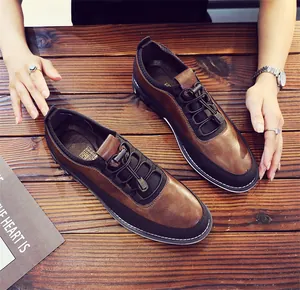 Brown leather business casual loafers with elastic laces on wooden table