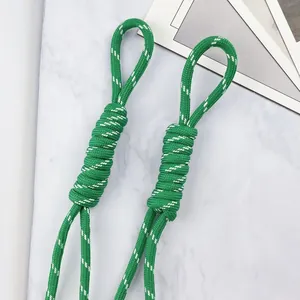 Detailed close-up of 5mm green woven lanyard with white dots for DIY keychain charms