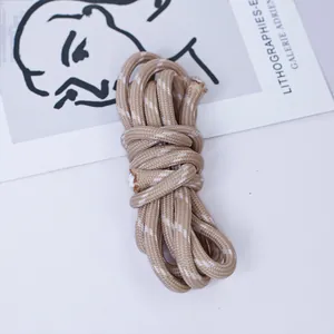 Macro view of 5mm khaki braided polyester cord with white dotted pattern for DIY