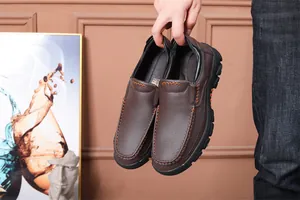 Detail view of men's brown leather slip-on loafers featuring high-quality cowhide.