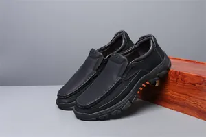 Side view detail of black leather men's casual slip-on loafers with durable rubber sole