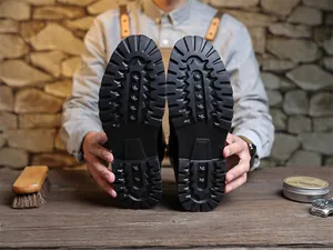 Detailed view of heavy-duty lugged rubber outsoles on men's vintage work boots
