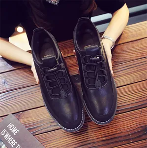 Close-up view of black breathable men's casual loafers on wooden table