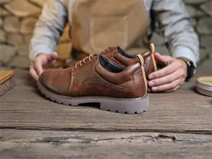 Nahaufnahme brauner Retro-Derby-Schuhe auf einer Werkbank in einer Schusterei