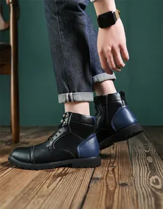 Detail view of retro leather Martin boots with blue heel accent and side zipper.
