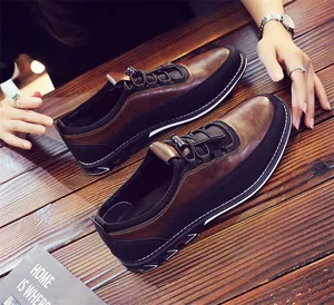 High-angle detail shot of brown and black breathable men's slip-on casual loafers