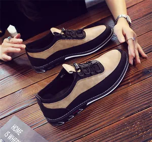 Close-up of stylish men's breathable slip-on loafers in black and tan leather