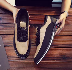 Detailed top view of breathable men's slip-on loafers displayed on a wooden table
