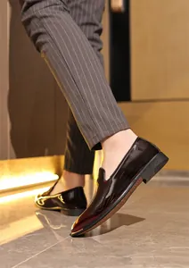 Detail view of glossy patent leather loafers for men's business attire