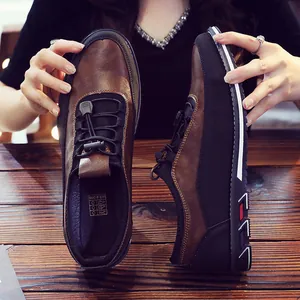 Brown and black men's casual leather loafers in a slip-on style for business or driving.