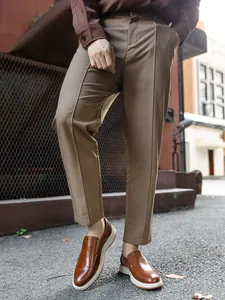 Close-up of stylish brown leather loafers for men worn in a casual outdoor urban setting