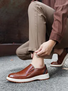 Detailed shot of men's brown leather business casual loafers with comfortable white soles