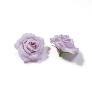 Vista ravvicinata di teste di rose artificiali viola con gocce di rugiada realistiche