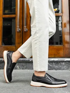 Side view of men's black leather loafers with thick white and brown soles
