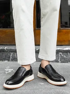 Close-up of men's stylish black leather loafers with thick soles in casual setting