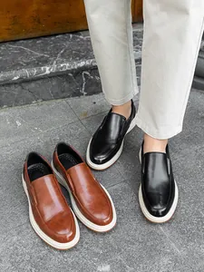 Stylish men's business casual loafers in black and brown leather with thick white soles.