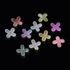 Detailed macro view of frosted acrylic four-petal flower beads with gold foil accents