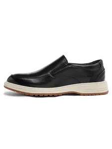 Side profile detail of elegant black leather loafers for men with a white and brown sole.