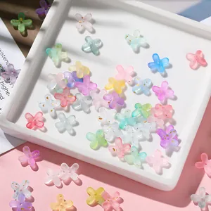 Detailed view of textured acrylic flower charms with shimmering gold leaf-like flecks