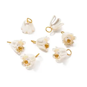 Close-up of iridescent ABS pearl lily of the valley flower pendants for DIY jewelry