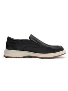 Side profile of business casual black leather loafers with a white and brown sole