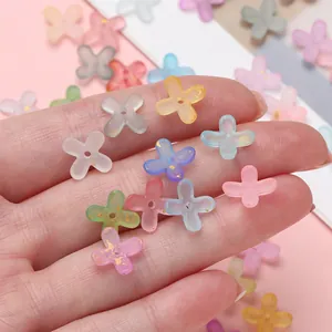 Close-up view of frosted acrylic four-petal flower beads with gold foil flecks