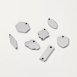 Macro view of blank stainless steel tags in geometric shapes for DIY jewelry engraving