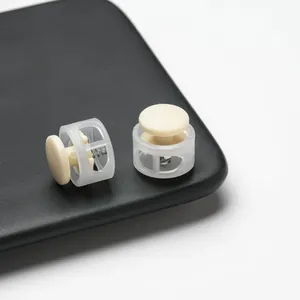 Close-up of round double-hole plastic spring cord locks for drawstring adjusters