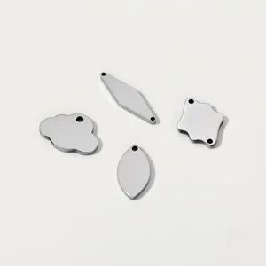 Detail shot of blank stainless steel jewelry tags in various geometric shapes for DIY
