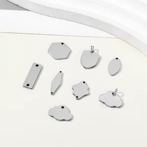 Close-up macro view of assorted stainless steel blank pendants for DIY jewelry making
