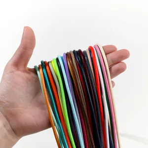 Bundle of 3.0mm multi-colored polyester wax cords held in hand for DIY jewelry