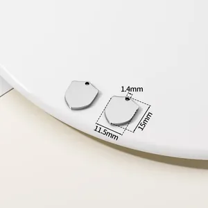 Detailed macro view of shield-shaped stainless steel pendant charm with 11.5x15mm dimensions