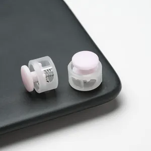 Close-up detail of pink plastic cord locks showing the internal metal spring mechanism.