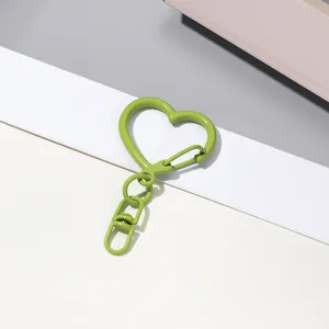 Gros plan détaillé d'un joli porte-clés mousqueton peint en forme de cœur vert vif