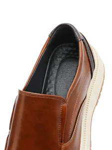 Detail shot of brown leather business loafers showing the collar and textured heel part.